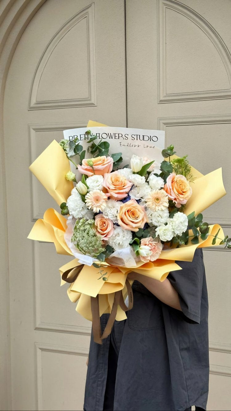 peach flower wrapped bouquet dallas florist