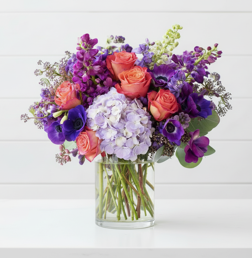 Bouquet of flowers in a clear vase on a white background